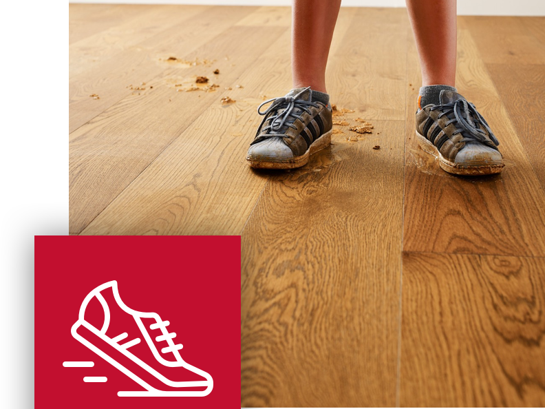 child with muddy shoes in hallway