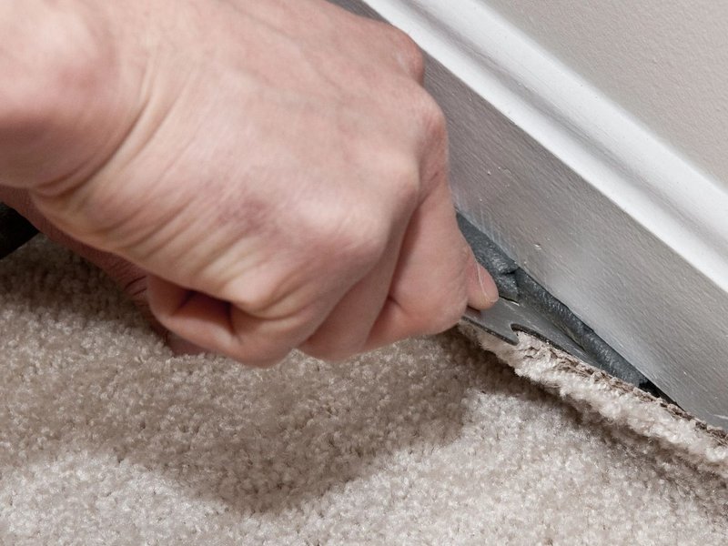 person installing carpet