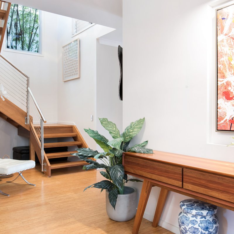 house foyer filled with furniture and hardwood floors