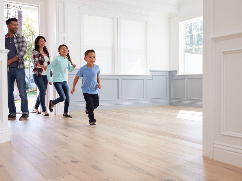 family with kids entering house