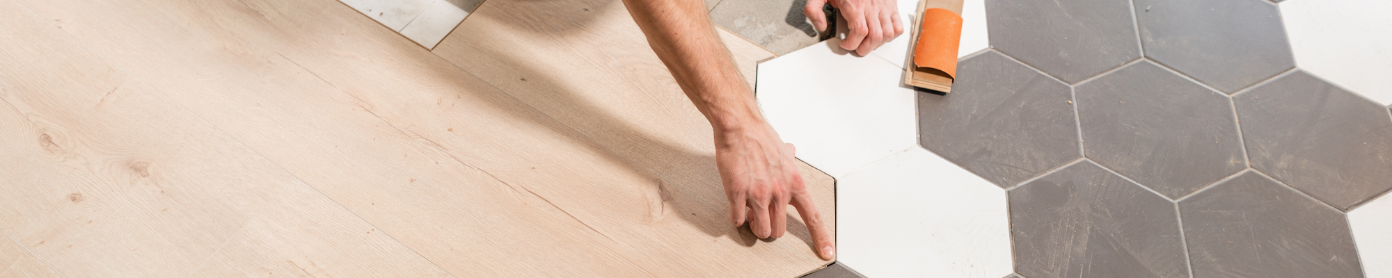 person installing tile flooring